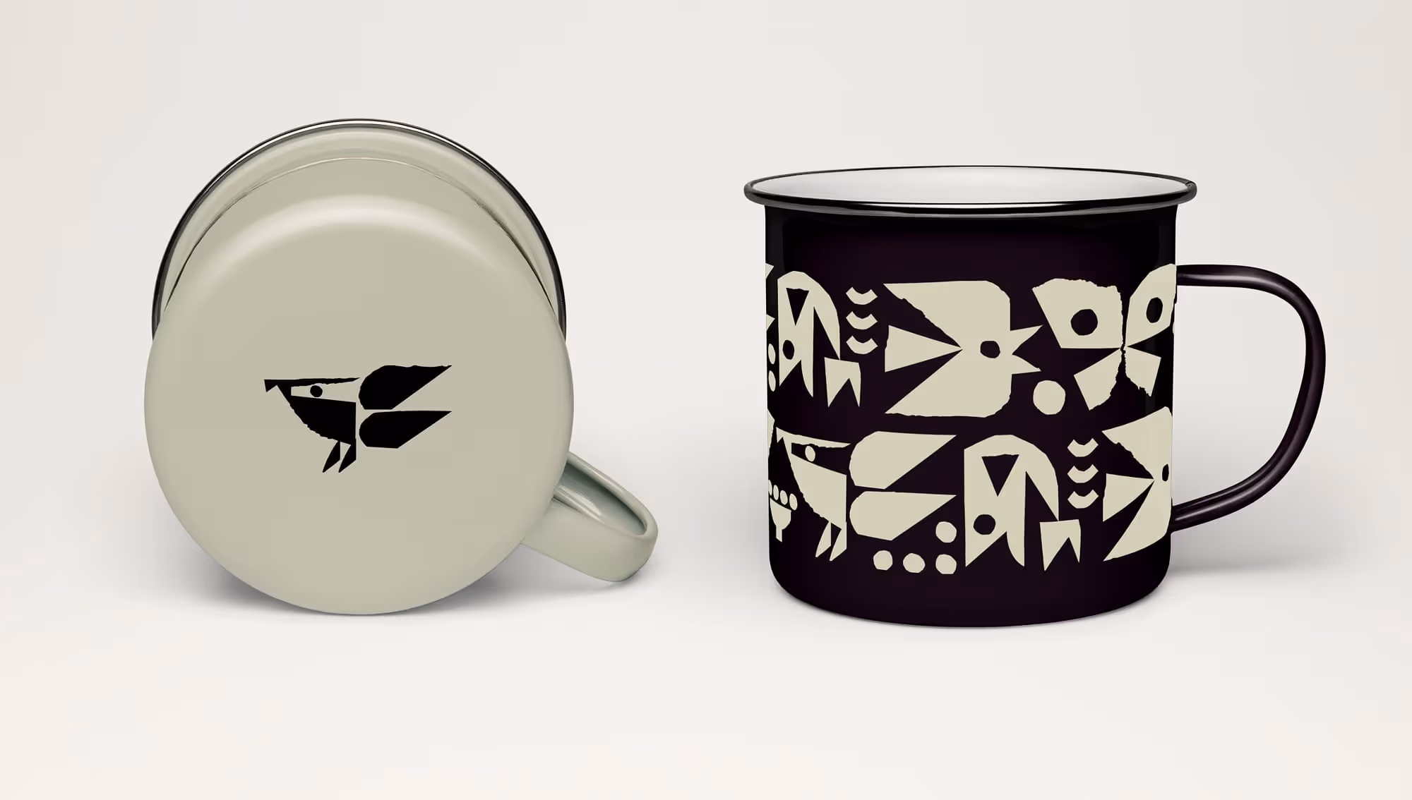 Two enamel mugs with wildglyphs depicting plants and animals that are found in the park.