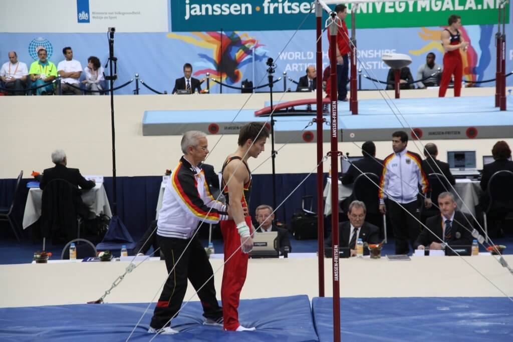 Coaching a gymnast on the bars