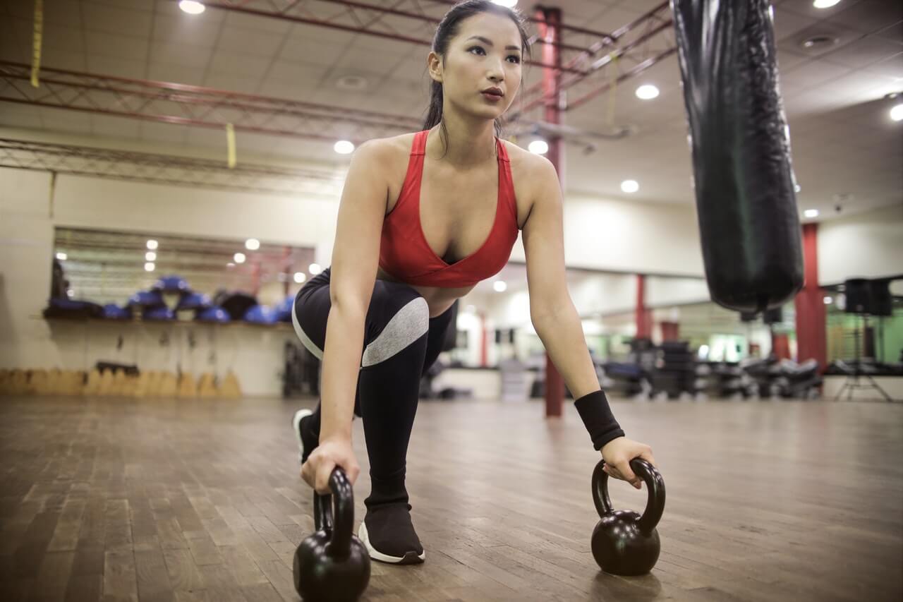 Woman training in the gym, representing our female athlete quotes