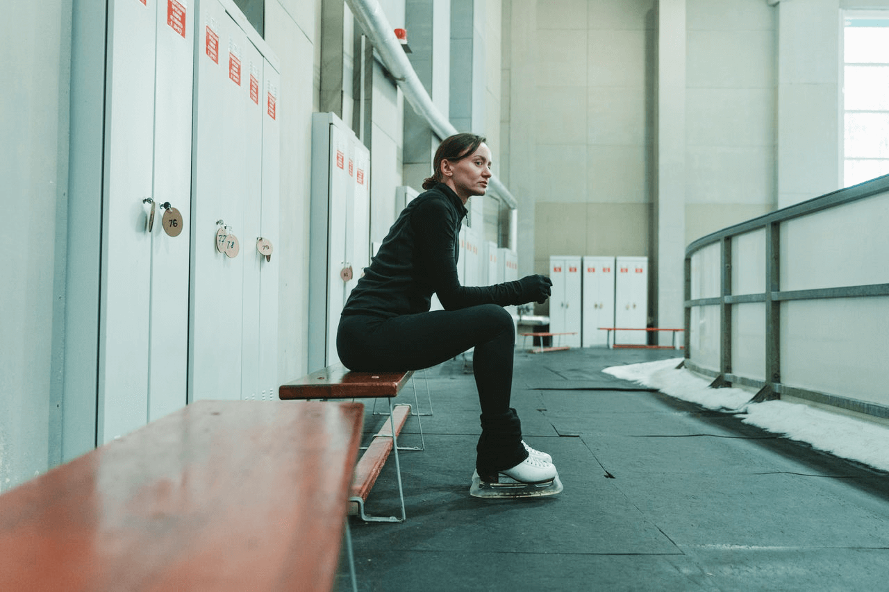 Determine figure skater sitting on a bench