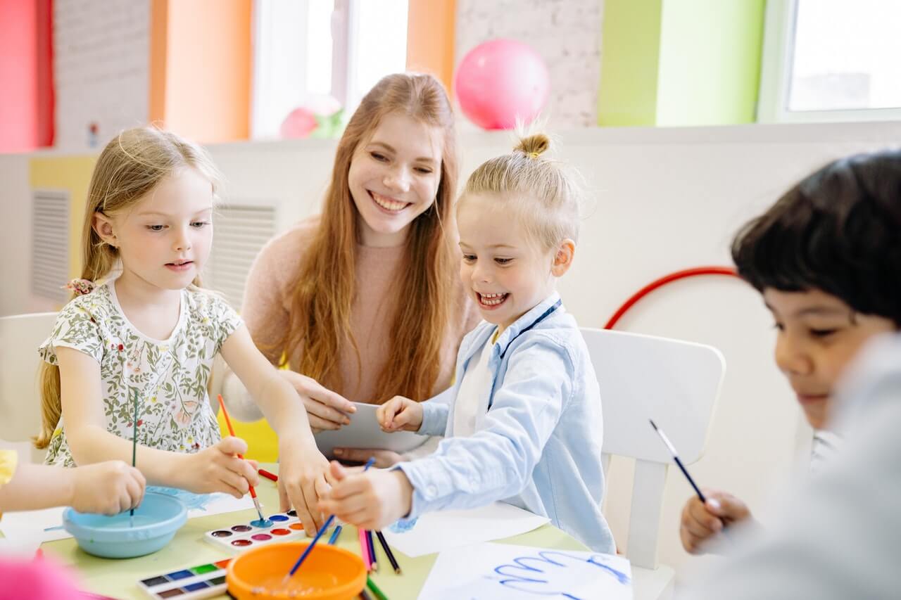 After school instructor teaching two students