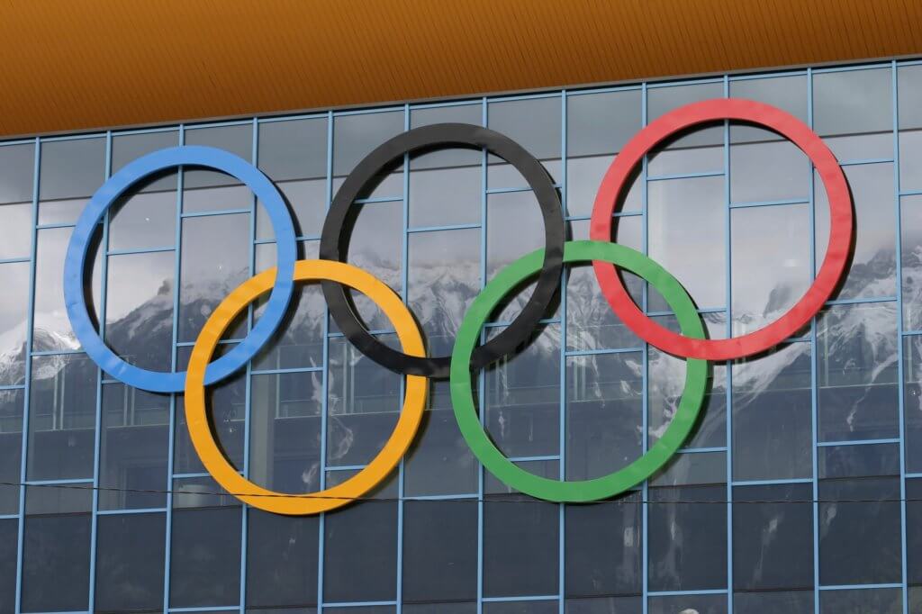 Olympic Rings hanging on a glass wall at the winter Olympics.