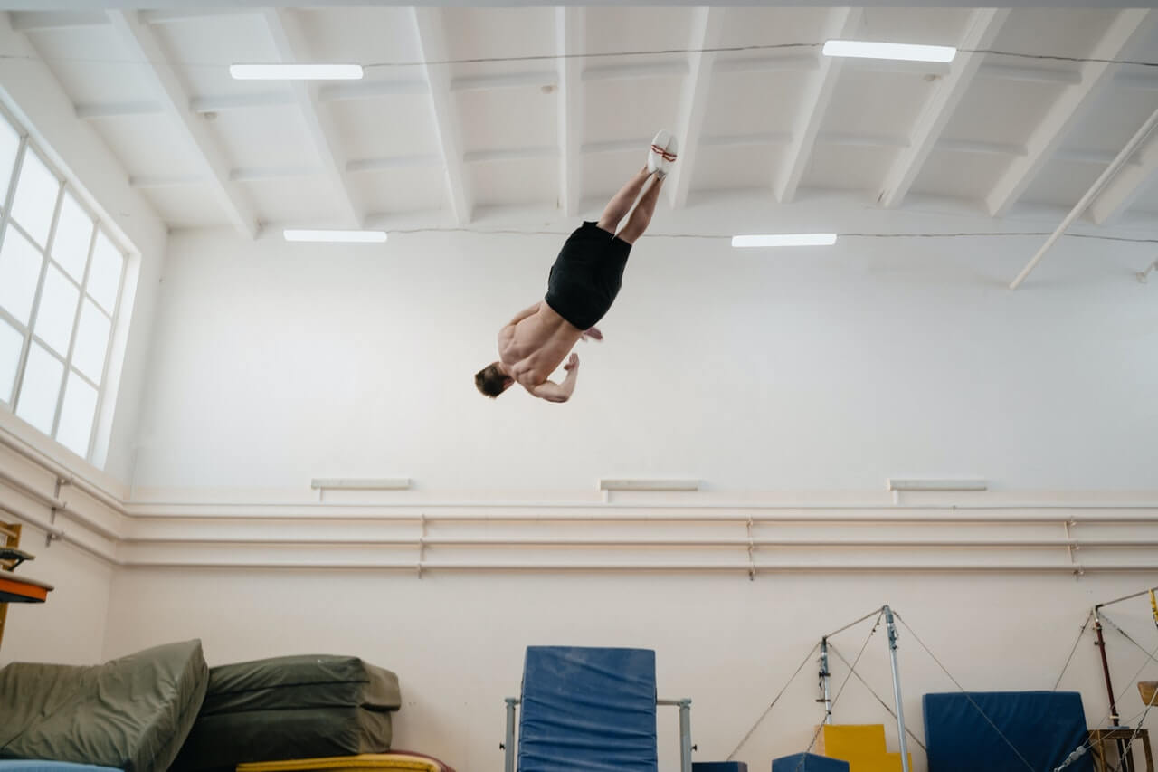 Gymnast completing twisting layout on trampoline