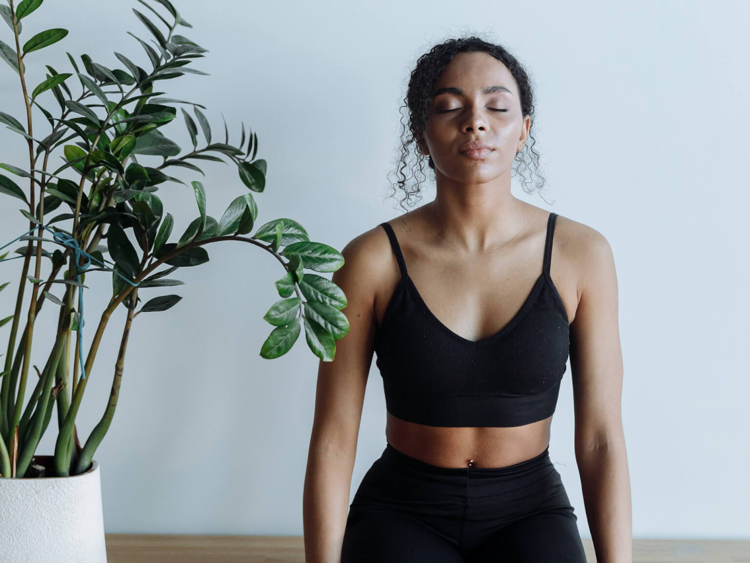 Woman meditating to promote mental health and wellness