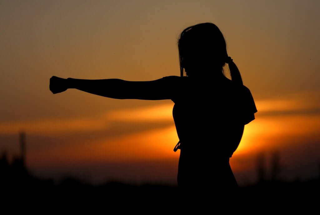 Karate striking practice at sunset.