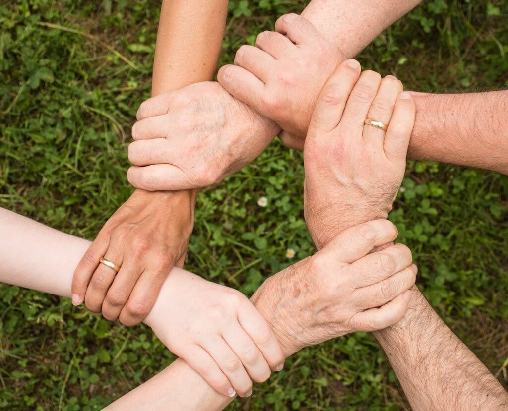 Community linking hands and sharing