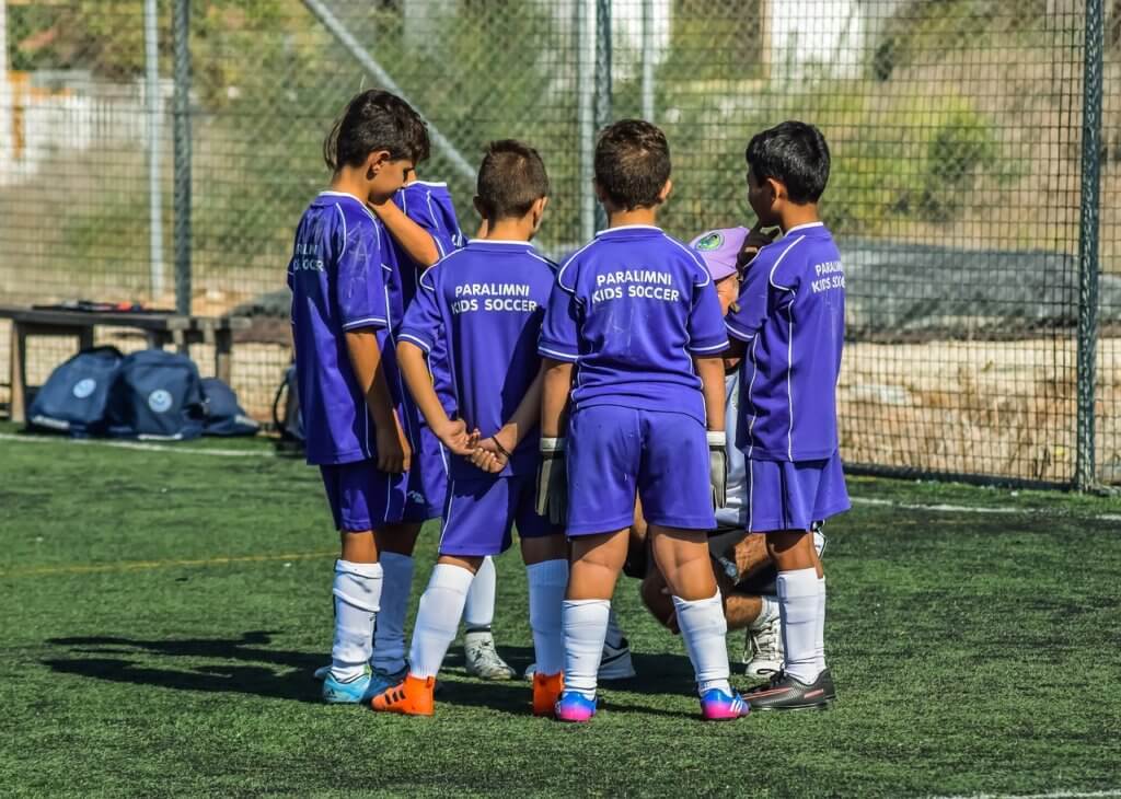 Soccer huddle for kids in a positive sports environment