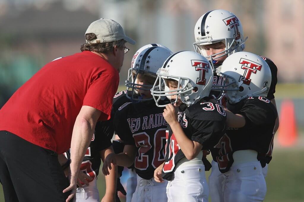 Football coach talking to football players. 
