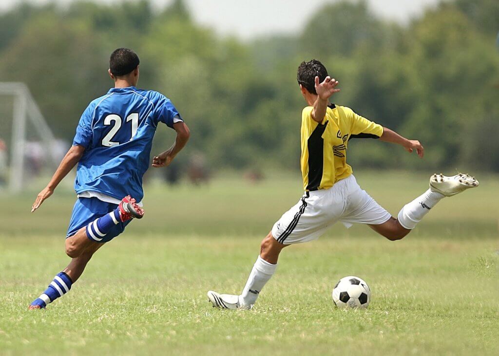 Young men playing soccer