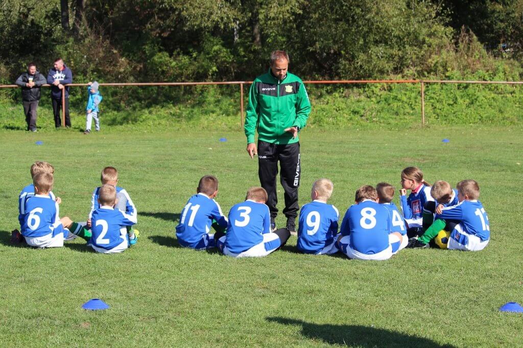 Soccer coach speaking to his athletes