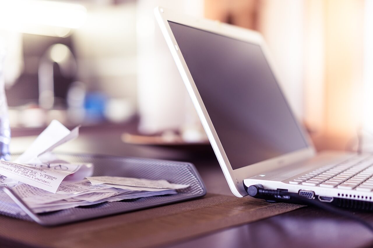 Digital invoicing for figure skating clubs featuring a computer and receipts