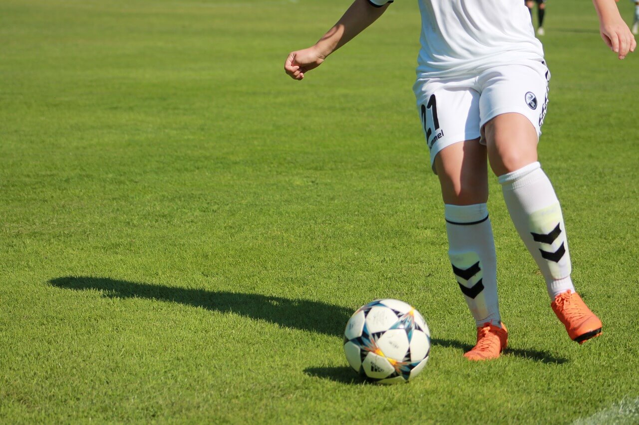 Soccer player dribbling the ball down the field