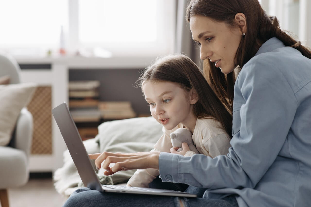 Mother and daughter checking their Uplifter family account for auto-renew fees