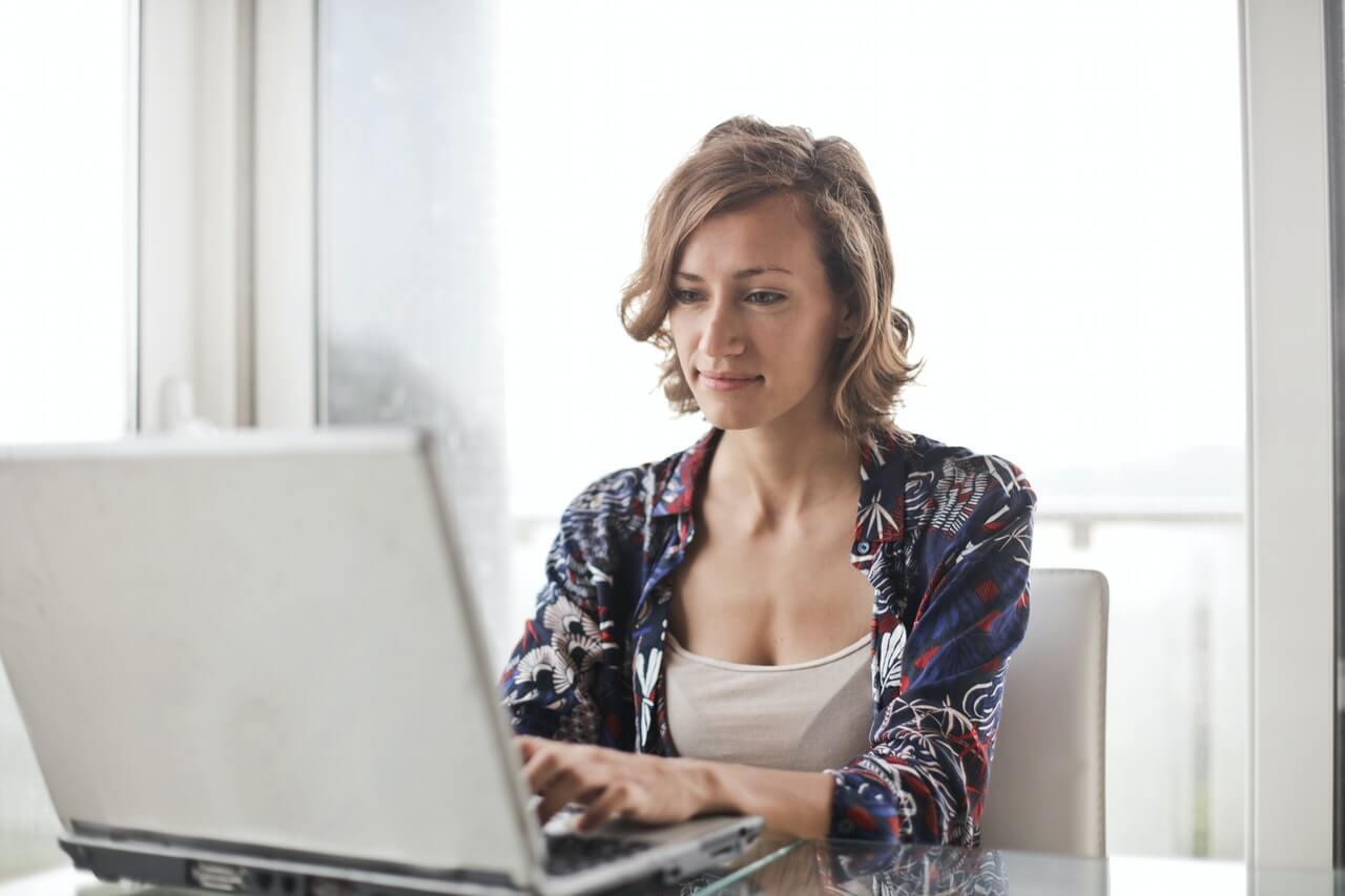 Woman performing self-serve withdrawal on a computer