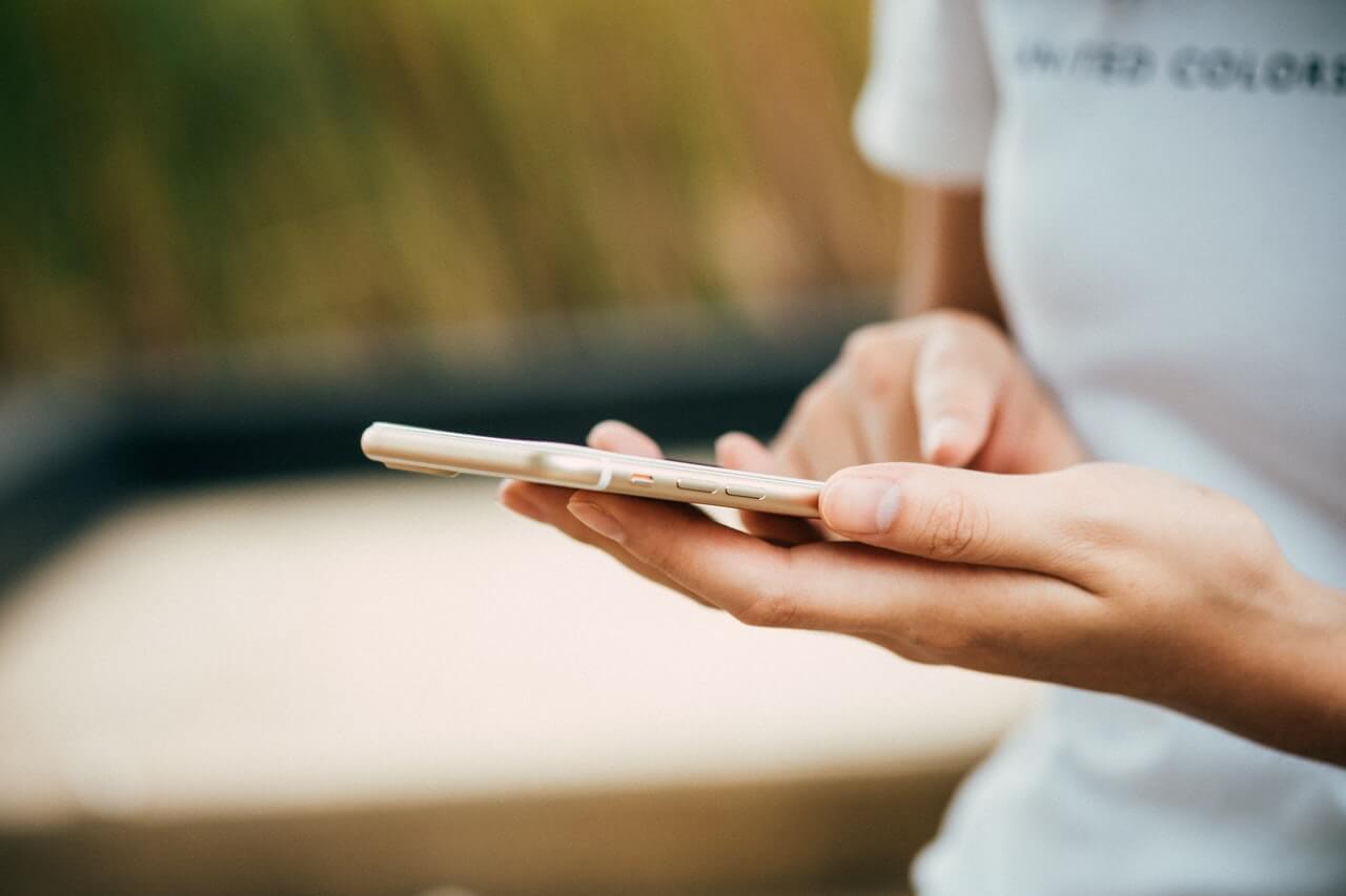 Woman checking automated payment reminder email