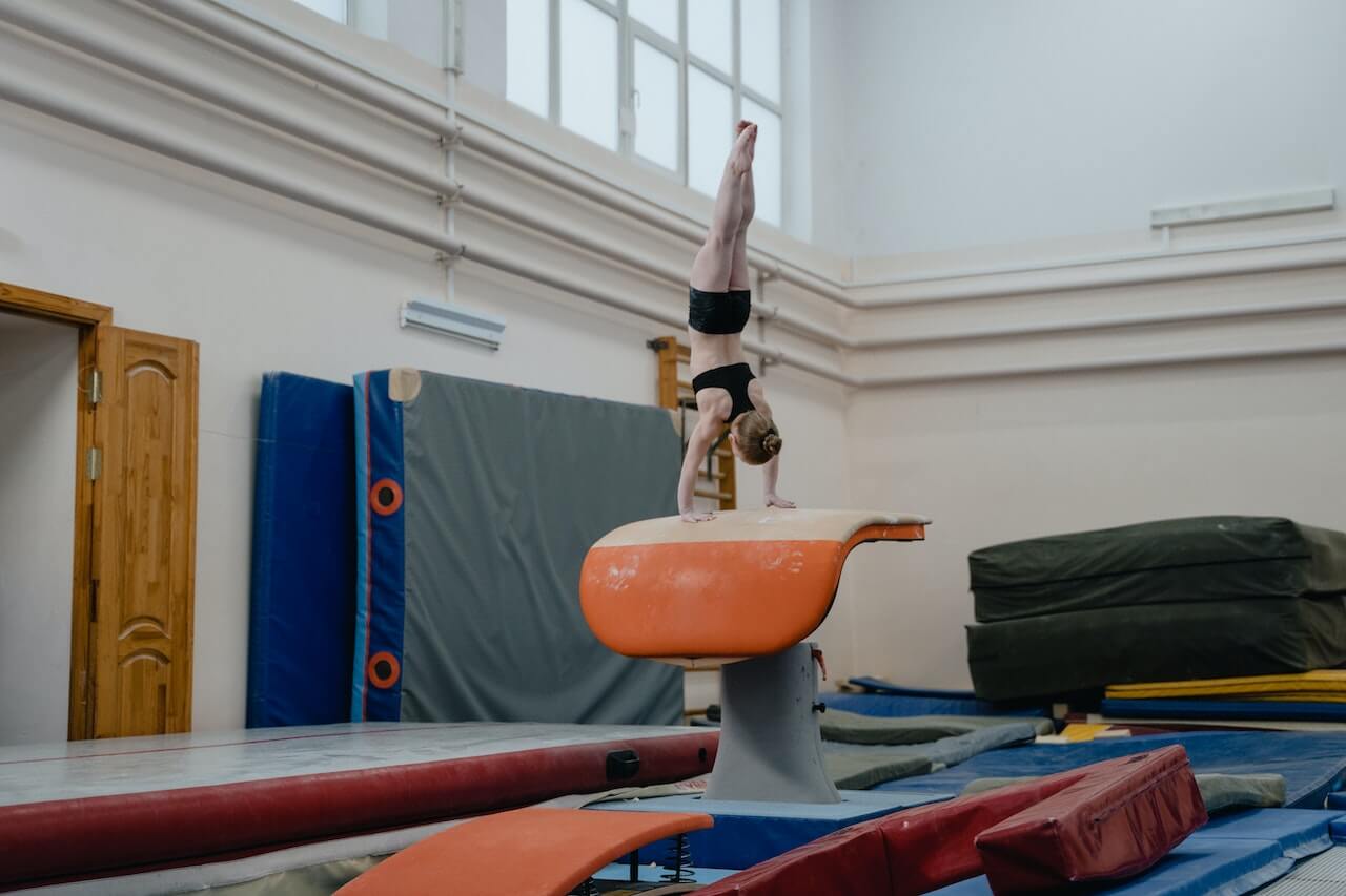 Gymnast using the vault in a gymnastics gym.