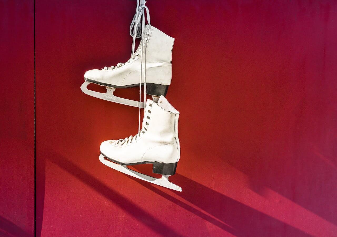 Figure skates hanging up on the wall.