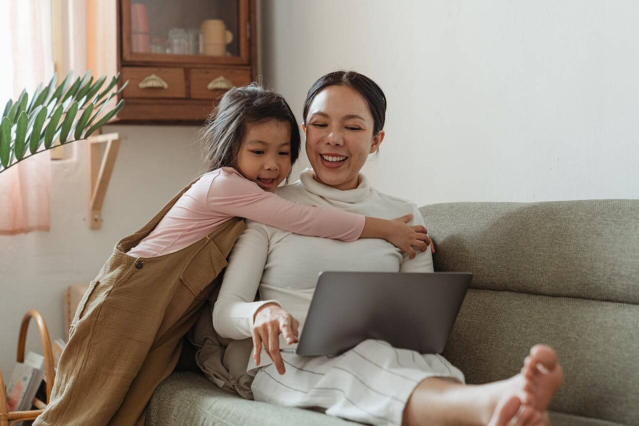 Mother celebrating her child's progress from her dance progress report. 