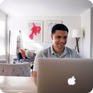 A person working on a laptop from their home office.