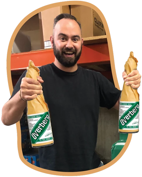 Uncorked team member having fun holding two giant bottles