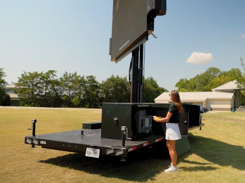 LED Videoboard with person controlling it with a remote attachment.