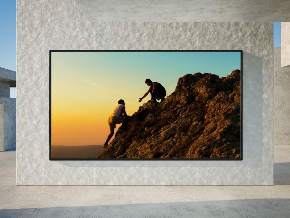 LED on the side of a wall with people climbing a mountain on it.