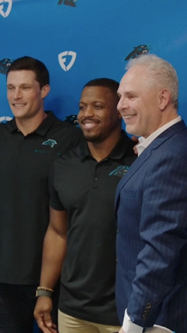 photos of executives taking a pictures against a fanduel backgrop