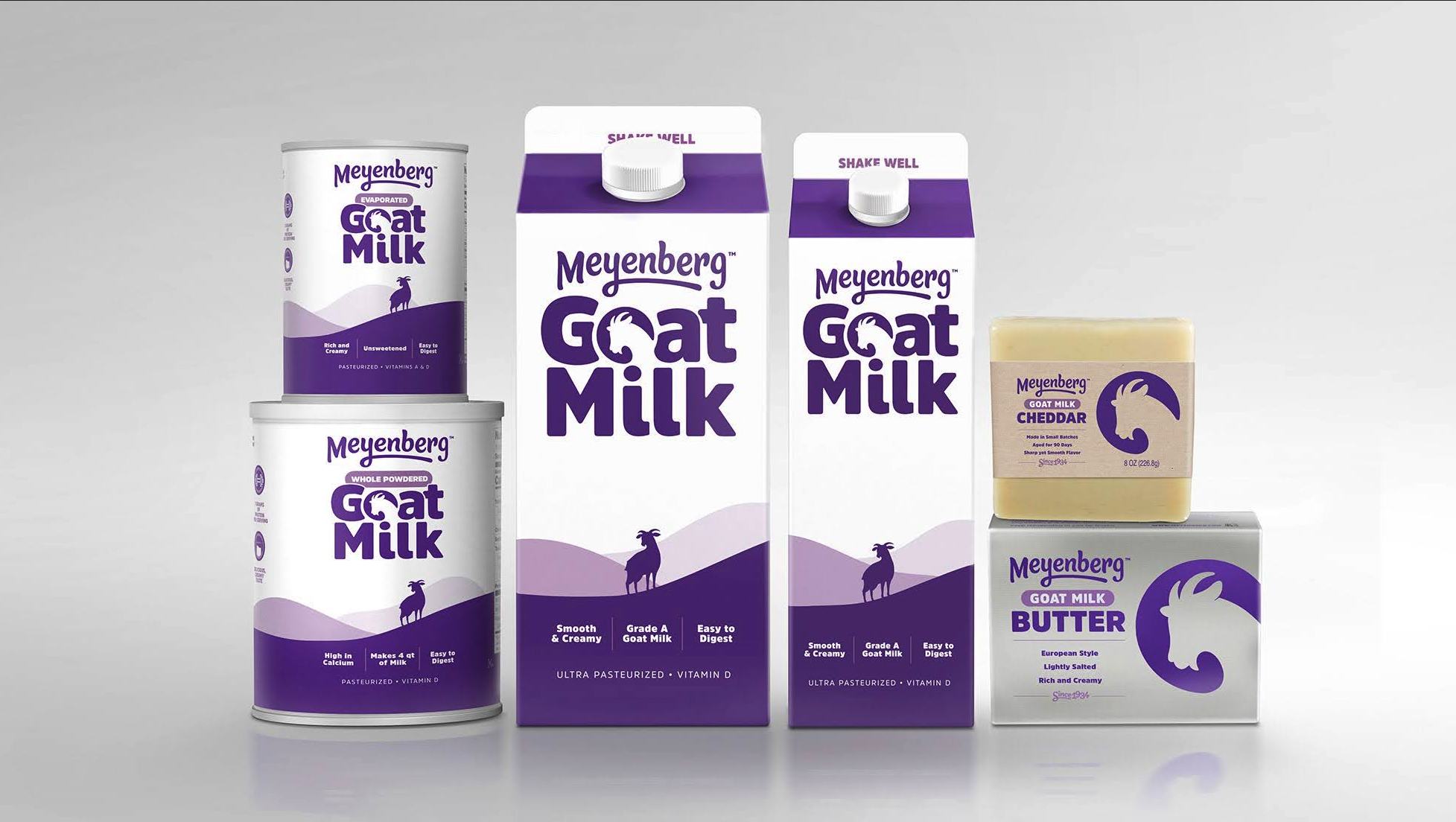 Lineup of Meyenberg goat milk products including goat milk cartons, cheese, and butter with new packaging.