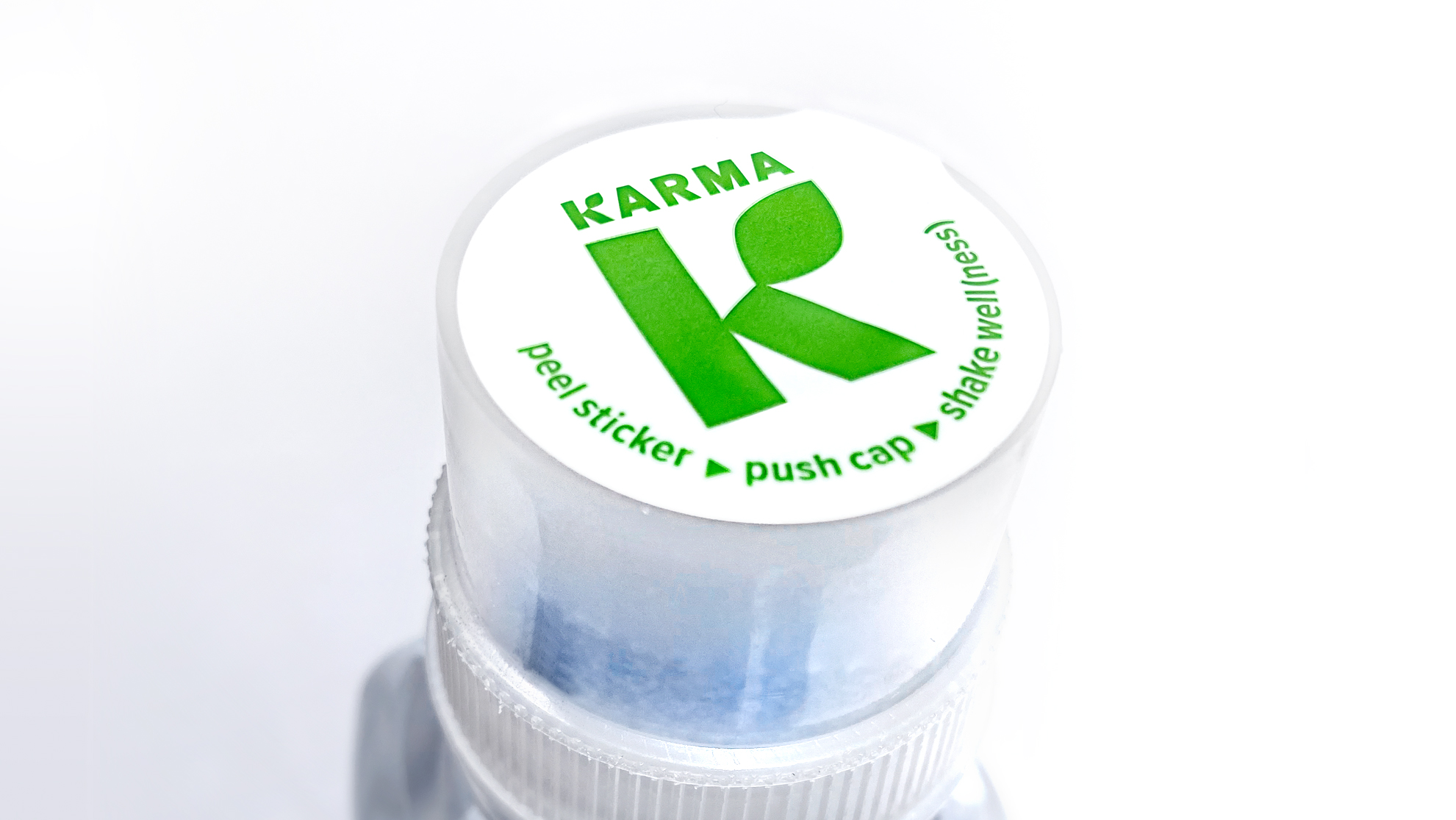 Cap of a Karma Water bottle with instructions to push cap and shake well.