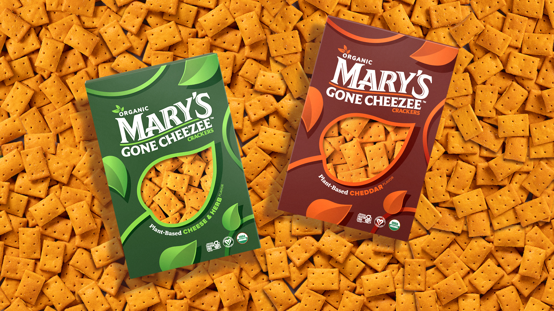 Two boxes of Mary’s Gone Cheezee in different flavors against a background of the orange crackers.