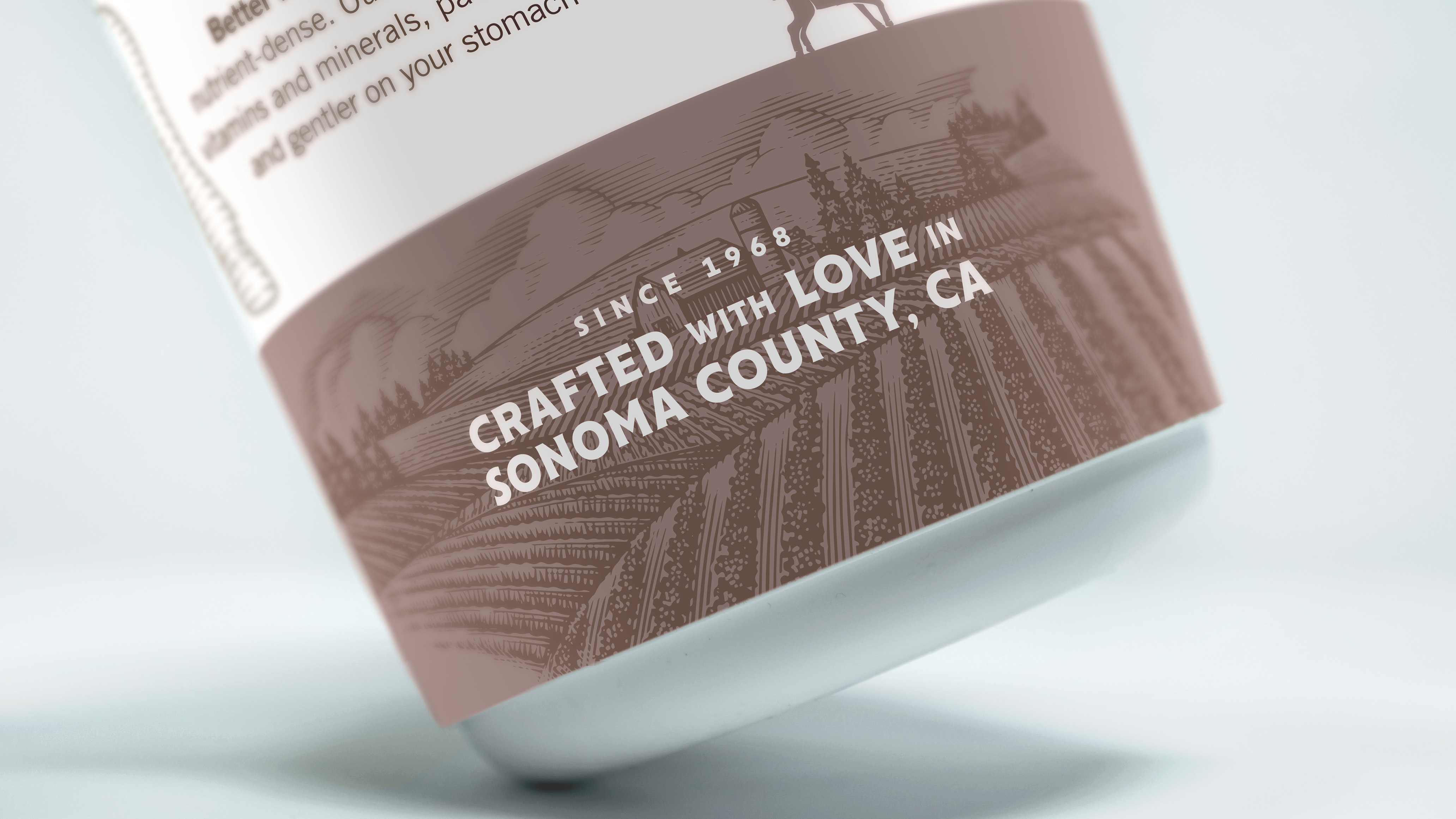 Tilted view of a Redwood Hill Farm yogurt cup with Since 1968, Crafted with Love in Sonoma County, CA line visible.