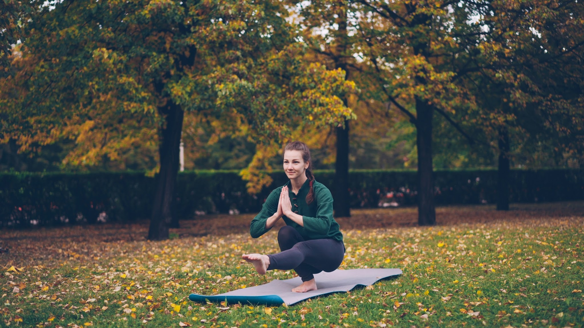 Person practicing yoga on a mat in a calming environment