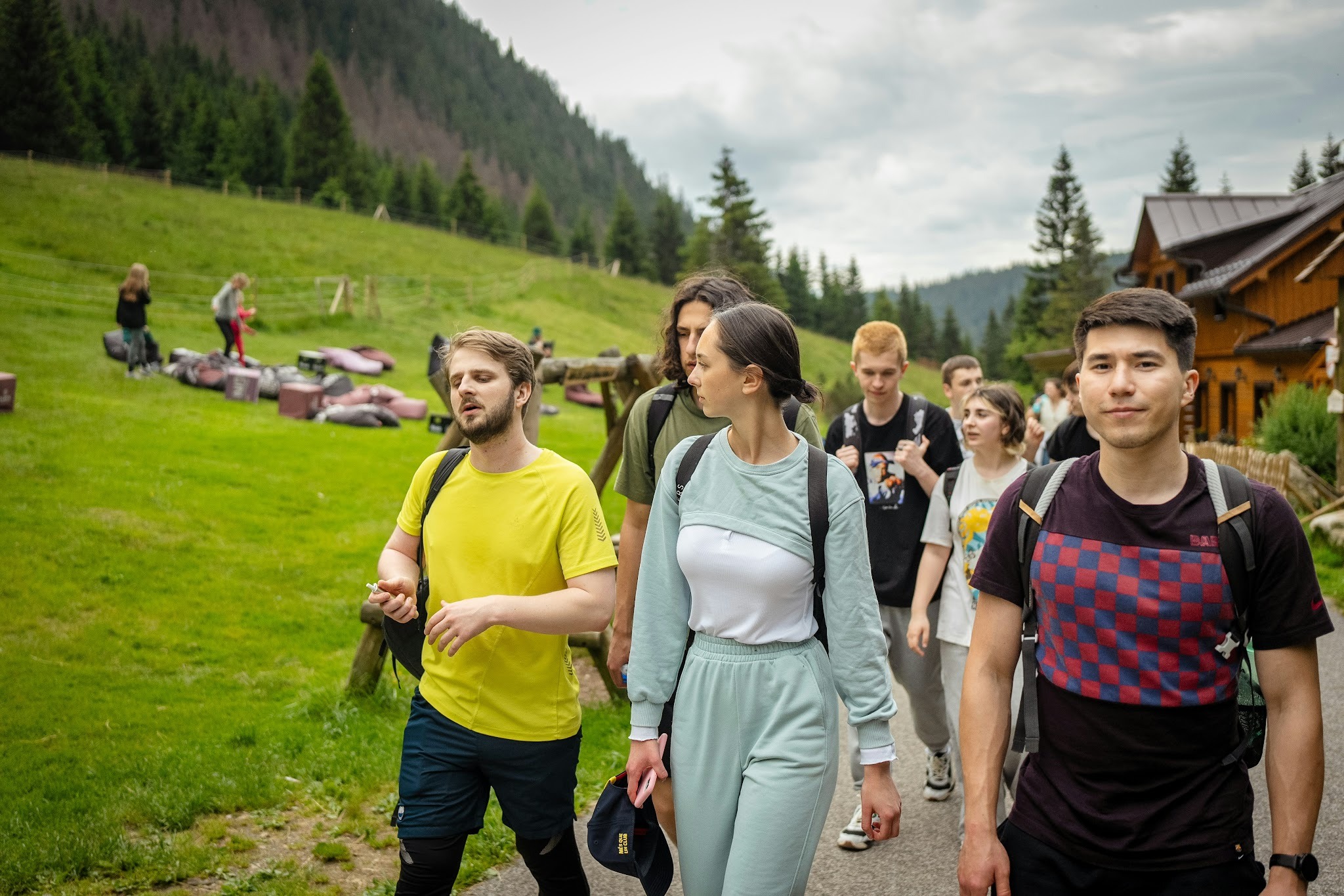 A group of friends supporting each other during a walk in nature