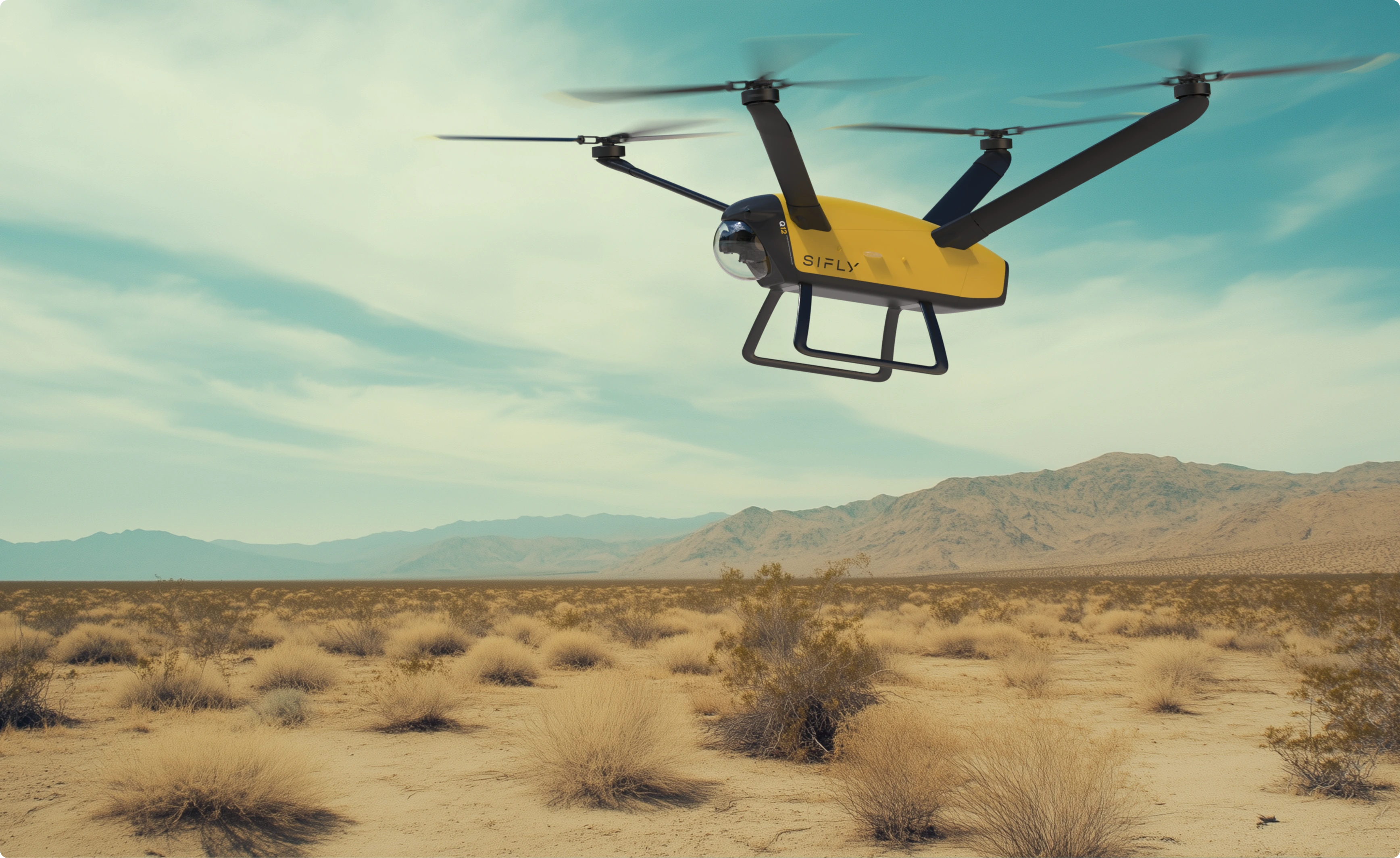 Yellow drone with four rotors flying over a dry desert landscape with mountains in the distance under a cloudy blue sky.