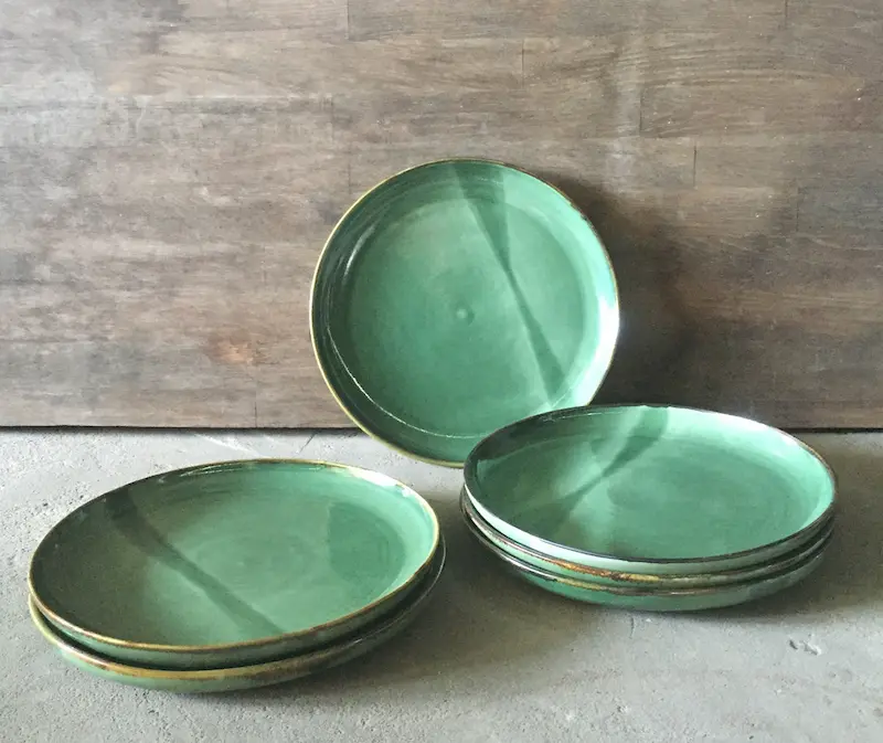 Vicki Randell, Tide lines dinner plates, 2020, stoneware, green glaze with ferrous rim, 23.5 cm diameter x 2.5 cm each, set of 6
