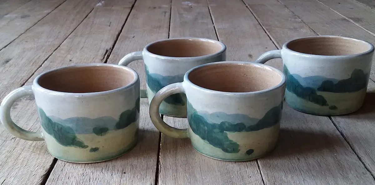 Yvette De Lacy, Landscape cups, 2021, stoneware, porcelain slip, underglaze, glaze electric kiln oxidation, 7 x 13.5 x 10 cm (per cup), set of 4