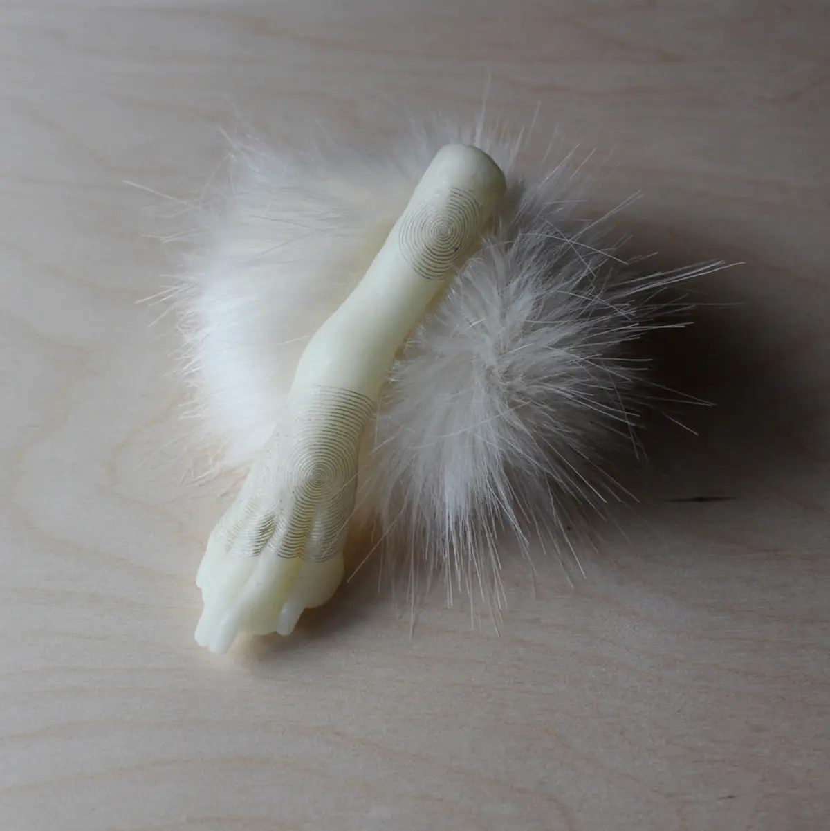 Kate Ellis, Untitled poodle paw, 2021, beeswax, silk thread, poodle fur & acrylic fur, 15 x 12 x 12 cm