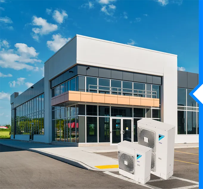 Modern white office building with glass windows and air conditioning units