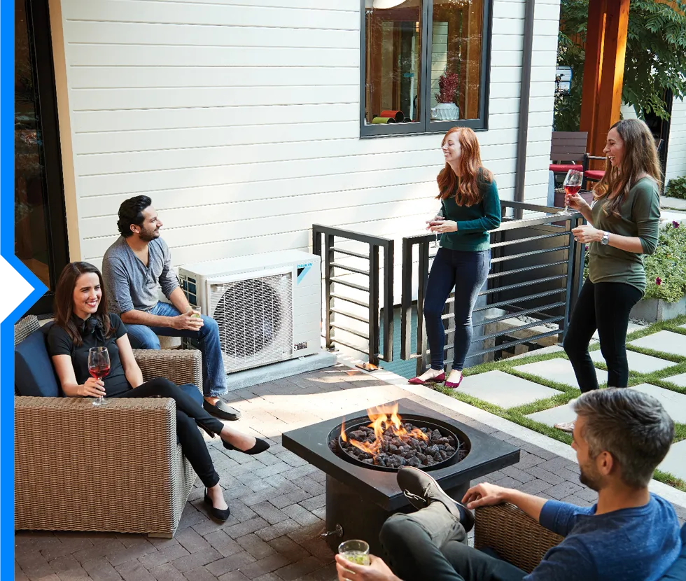 Friends enjoying wine and conversation around a fire pit on a patio