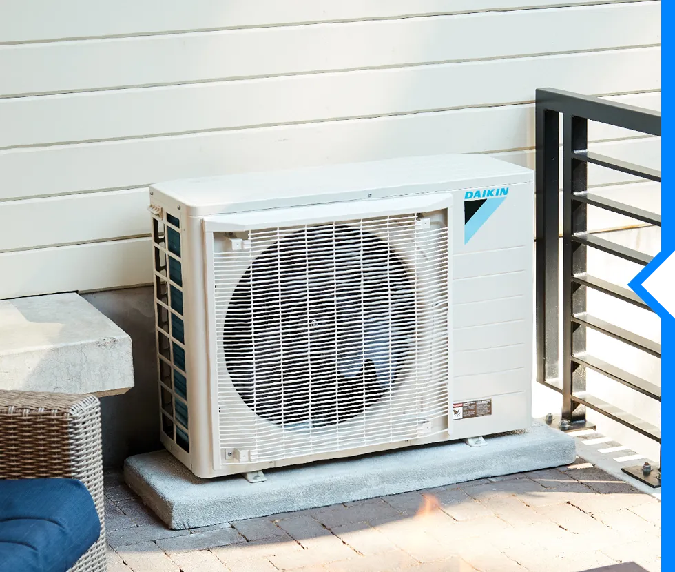 Daikin air conditioning unit installed outside on concrete pad