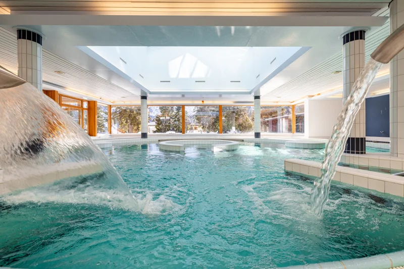 Curving lazy river channel in the indoor wellness area at Altein, Arosa