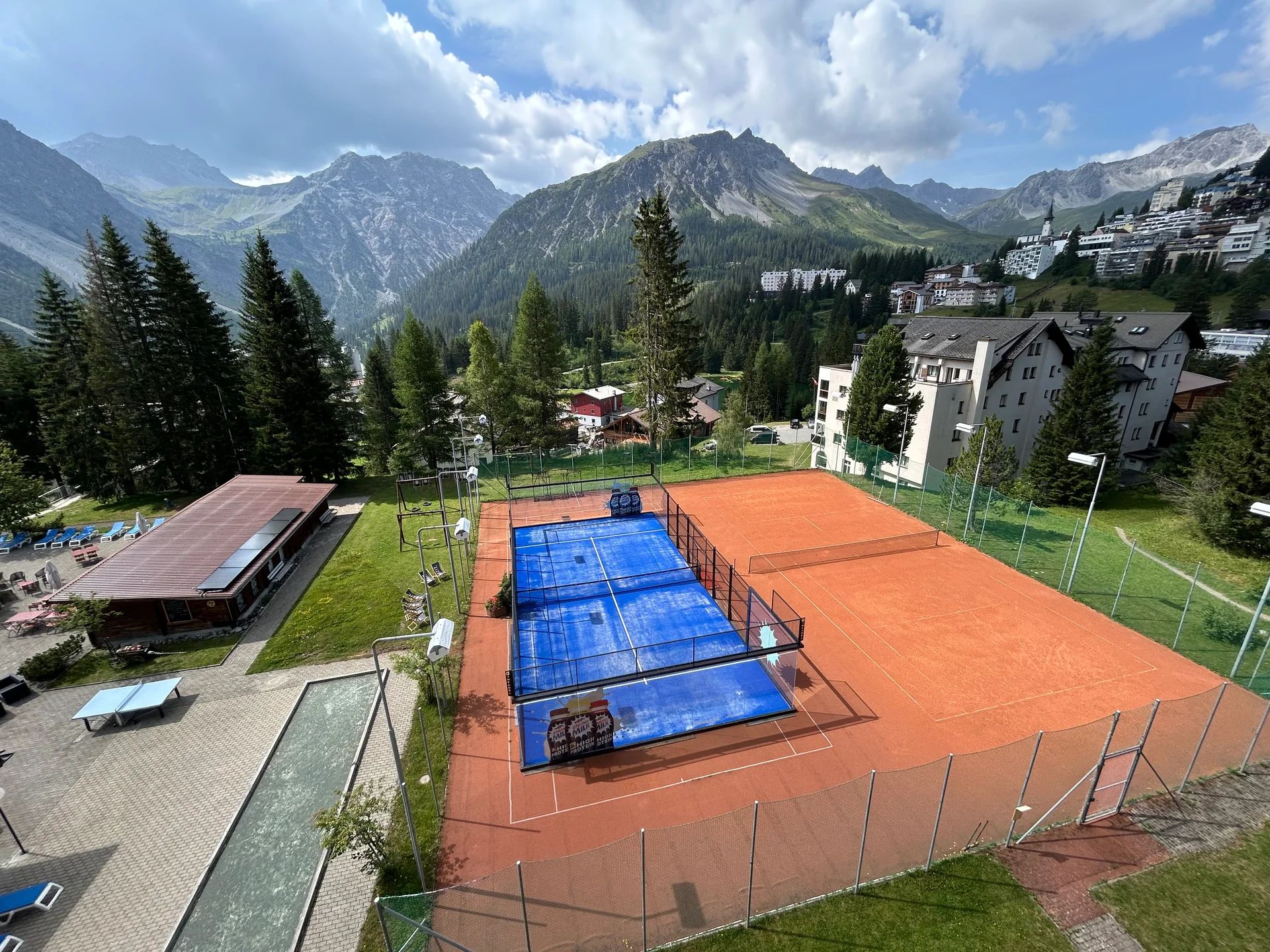 The padel court, tennis court and boccia lane on the grounds of Altein, Arosa, seen from above