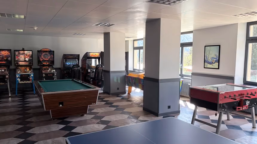The games room at Altein, Arosa, with pool table, pinball machines, arcade games and table football