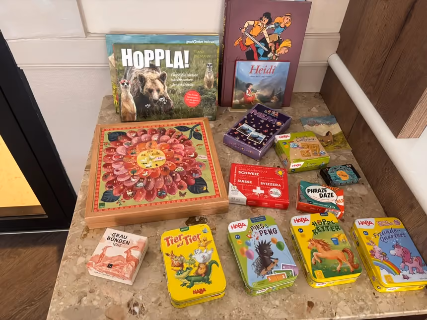 Board games, card games and children's books available at reception at Altein, Arosa