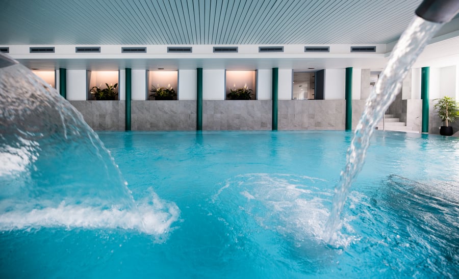 Hydromassage jets along the wall of the indoor pool
