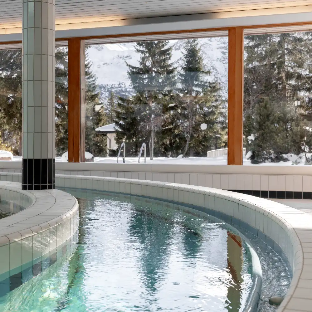Whirlpool in the Altein spa with snowy trees outside