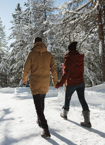 Four people paddleboarding on a misty lake at sunrise with mountains in the background.