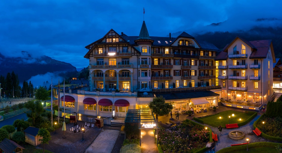 A large building lit up at night with lights on
