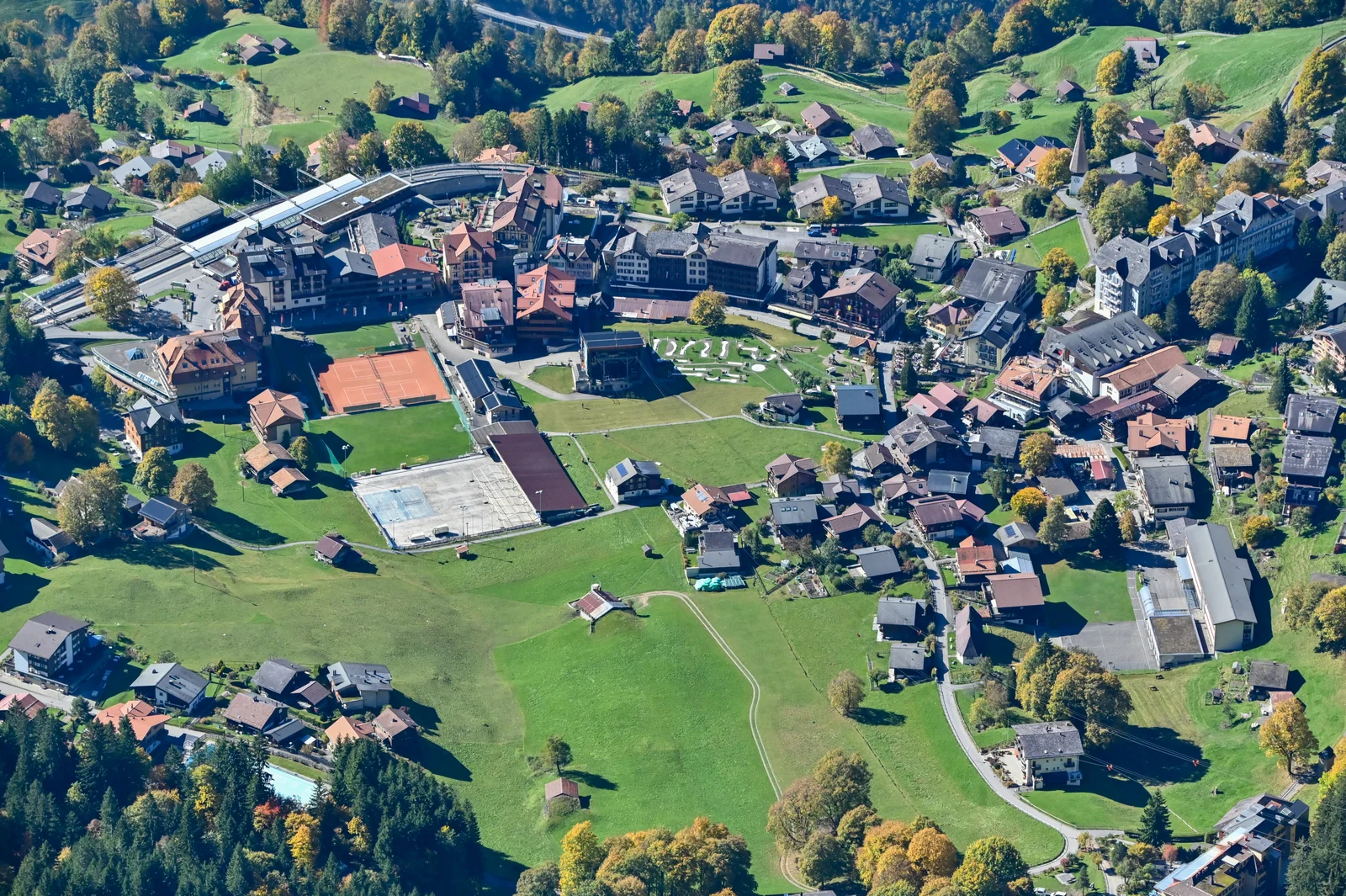 Aerial view of car-free Wengen village on its sunny terrace above the Lauterbrunnen Valley