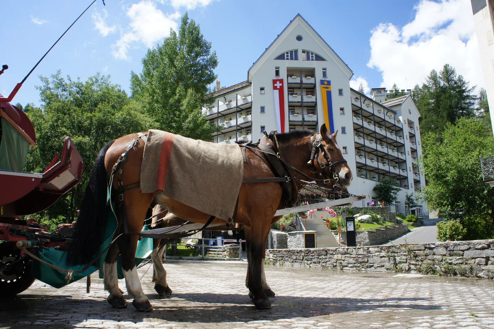 Horse-drawn carriage outside the Schweizerhof, a gateway to car-free Val Fex
